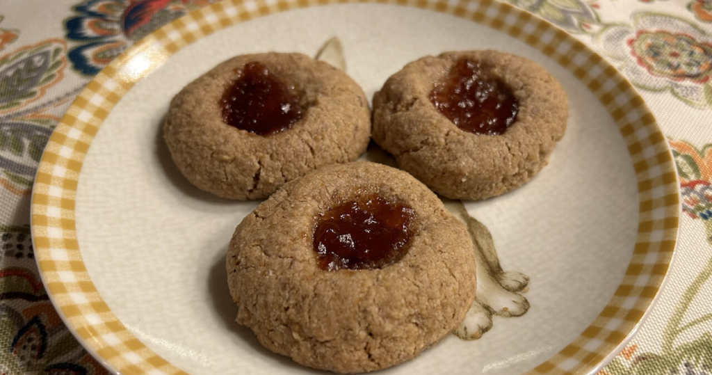 3 healthy, low sugar thumbprint cookies sit on a plate