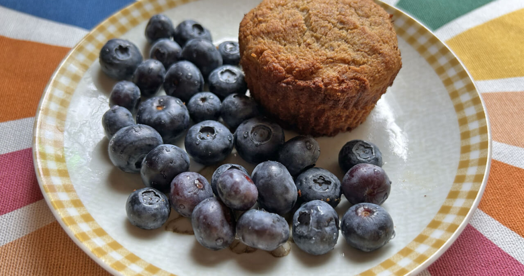 Tigernut Muffin and blueberries on a small plate